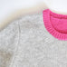 close up of neckline from knitting pattern, sweater knitting pattern, jumper knitting pattern.  Grey and bright pink jumper 