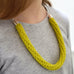 woman wearing yellow version of chunky crochet necklace
