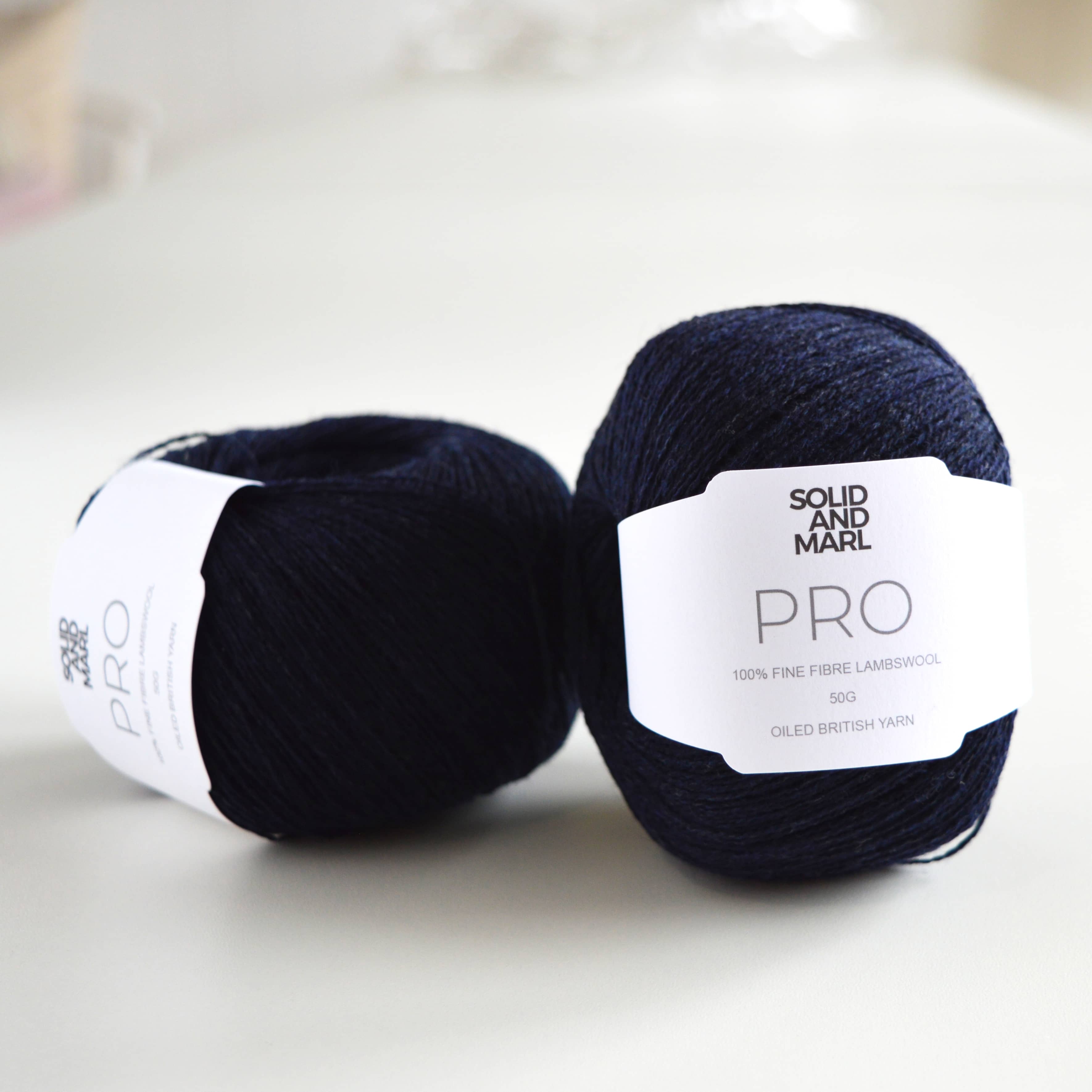 ball of navy yarn on table, pure wool, british wool, pure lambswool