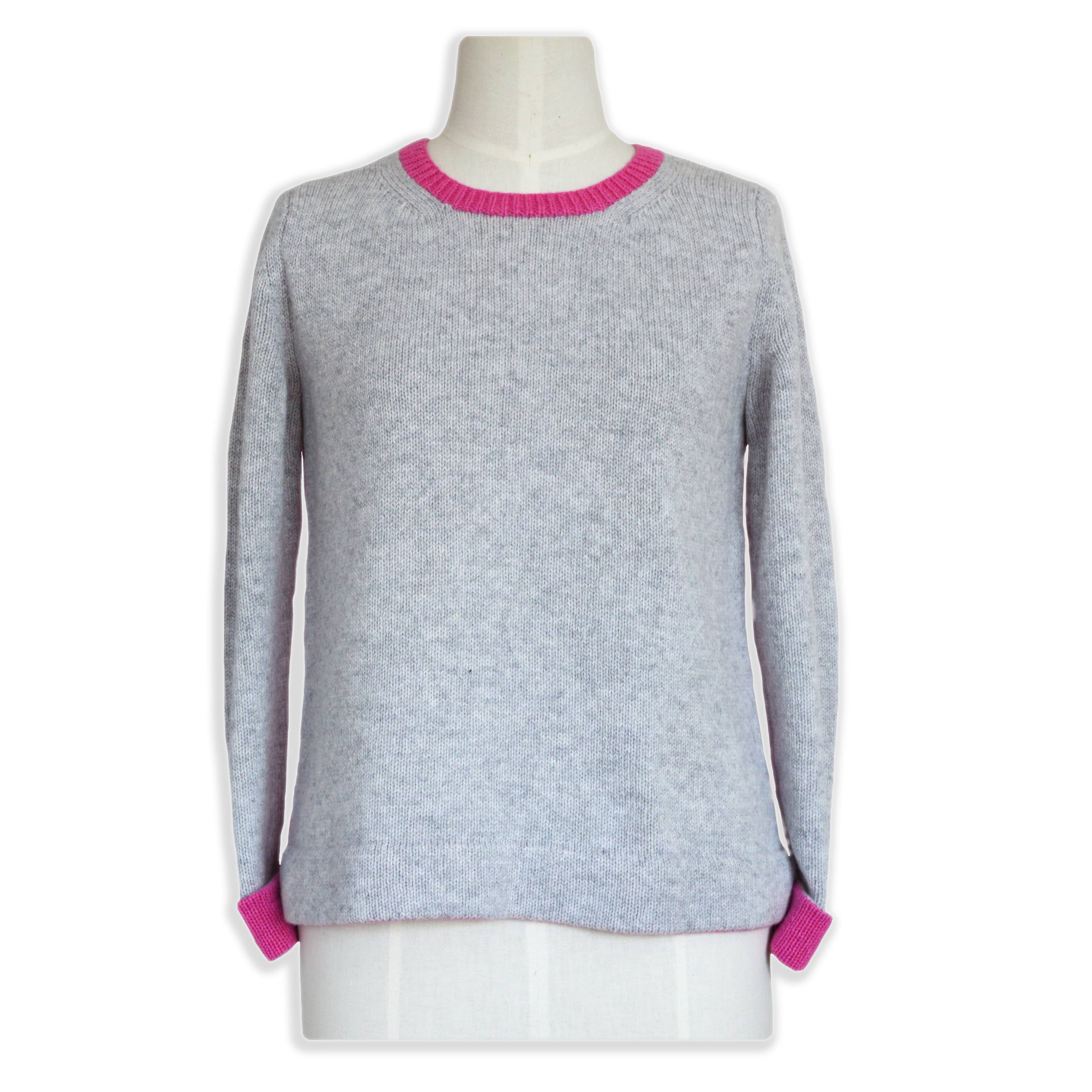 knitting pattern sweater on stand to show finished jumper. grey and bright pink modern crew neck sweater