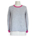 knitting pattern sweater on stand to show finished jumper.  grey and bright pink modern crew neck sweater