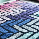 close up of crochet blanket in blue and green colours