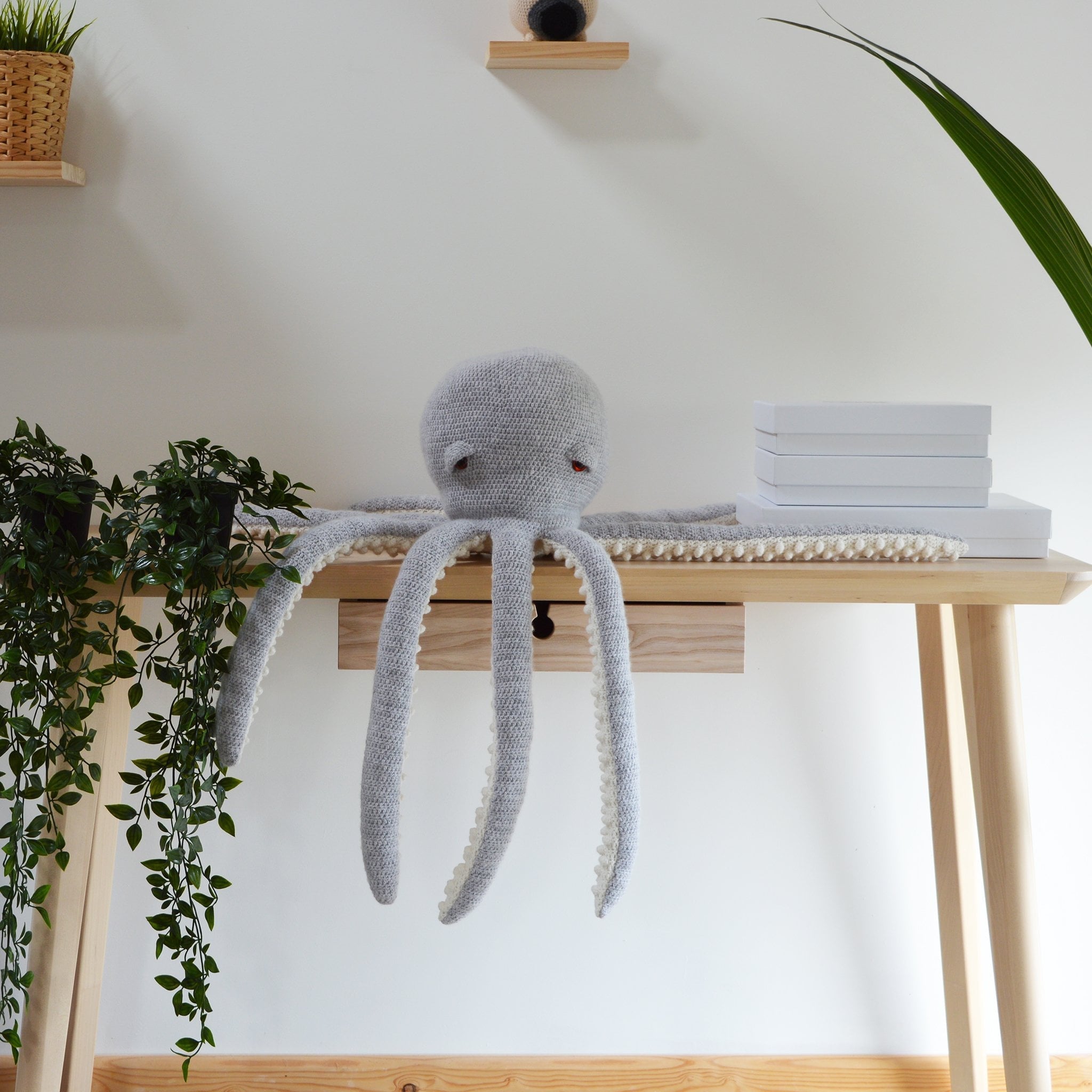 large modern octopus crochet kit in modern room setting with plants