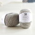 ball of grey yarn on table pure soft lambswool, pro yarn. british yarn