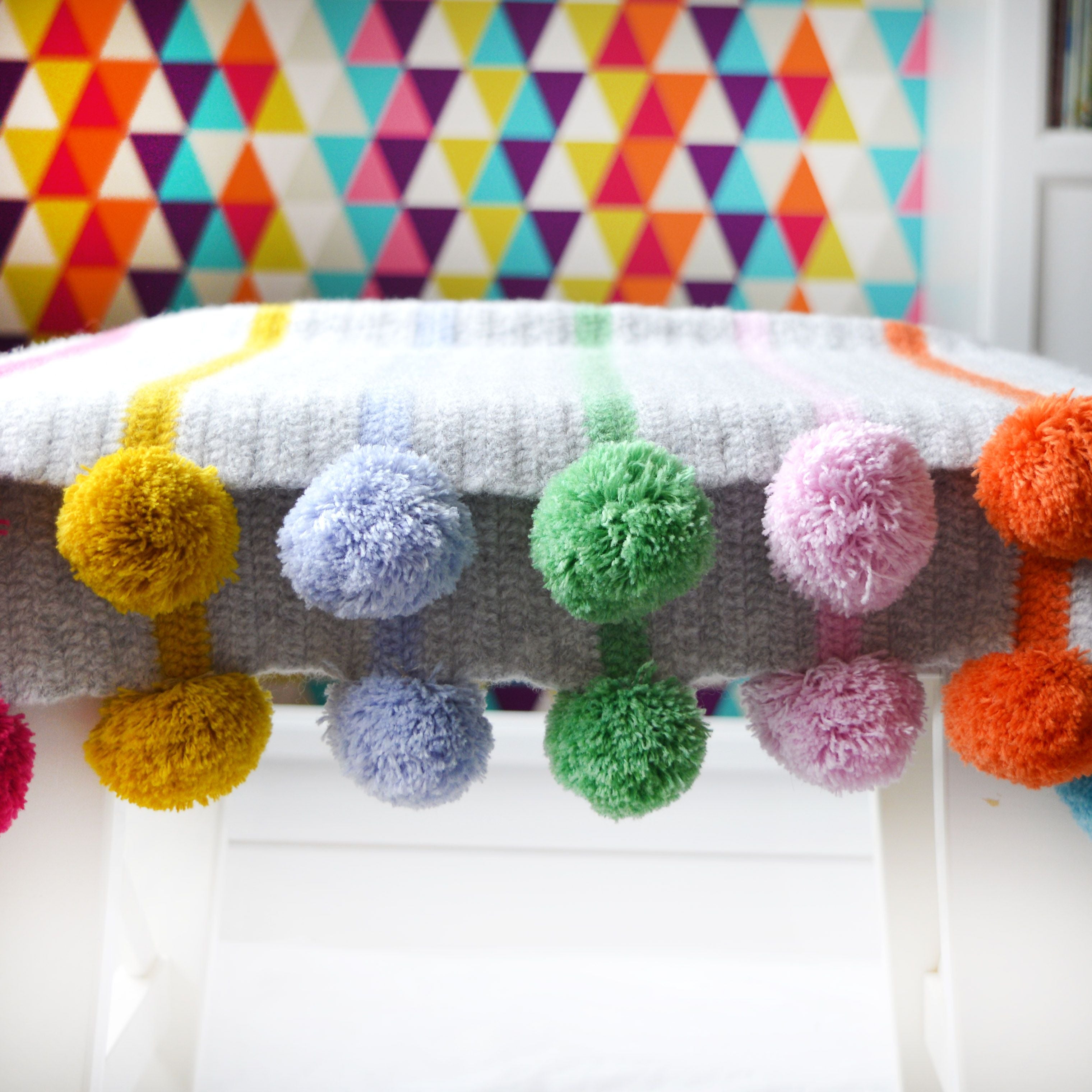 pom pom and stripe crochet blanket kit close up of pom poms