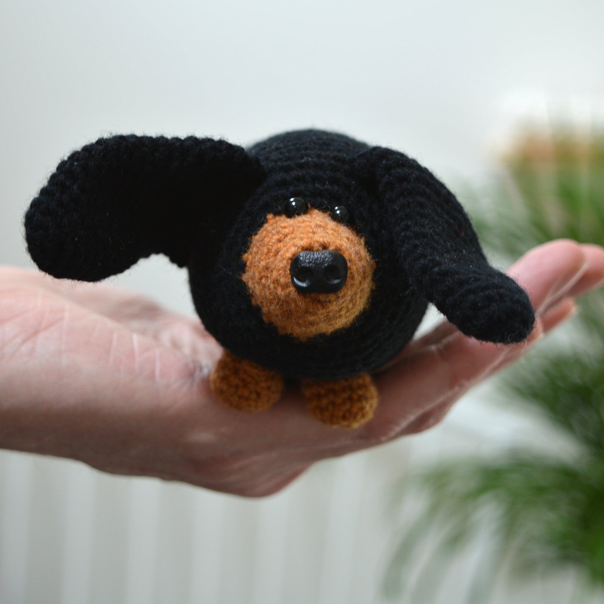 amigurumi sausage dog crochet kit held in hand