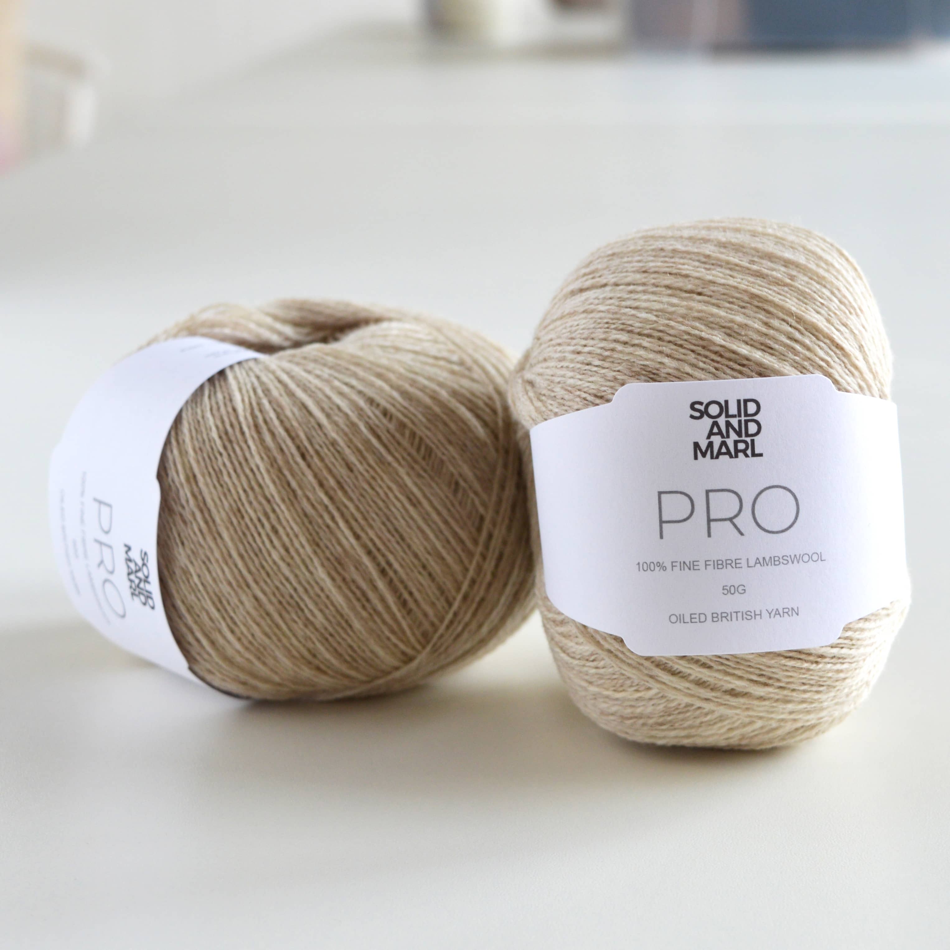 beige ball of wool on table, pure lambswool, british yarn
