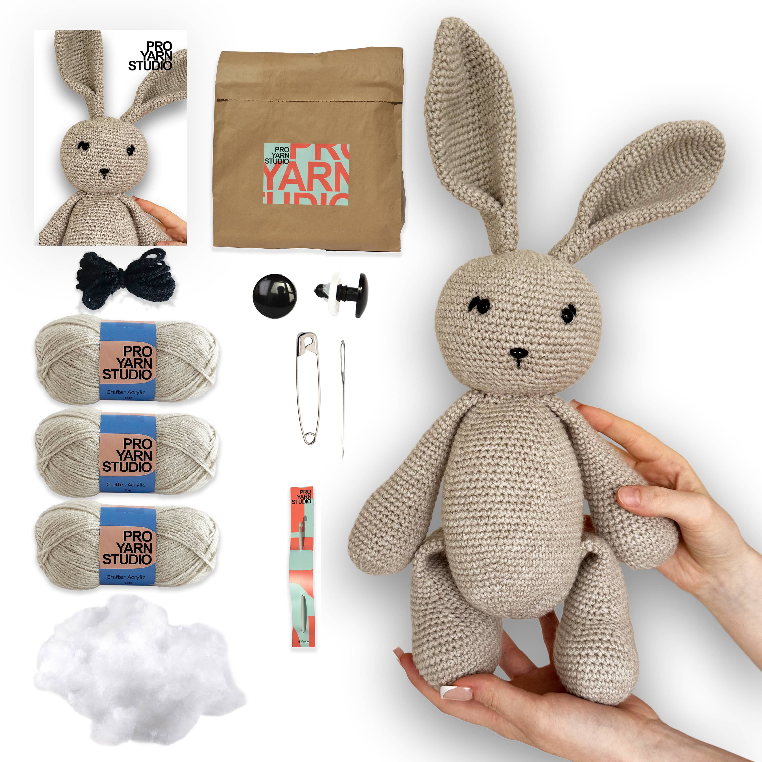 Crochet bunny kit with yarn, needles, and other supplies on a white background