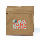 Brown paper bag with 'Pro Yarn Studio' logo on a white background