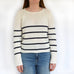 woman wearing modern lace knitting pattern jumper sweater.  with white and navy stripes