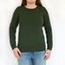woman wearing jumper knitted from knitting pattern, green stocking stitch jumper