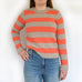 woman wearing modern jumper from knitting pattern.  Young and fun knitting.  orange and brown stripe jumper