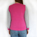 back view of woman wearing jumper from knitting pattern.  sweater knitting kit, sweater knitting pattern, modern knitting, bright pink and grey