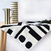 abstract modern art crochet blanket kit in black and white draped on table