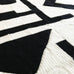 close up of crochet blanket in black and white with a modern art abstract design 