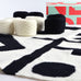 black and white abstract modern art crochet blanket kit showing yarn and box
