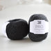 ball of charcoal yarn on table, pure wool, charcoal lambswool, british yarn