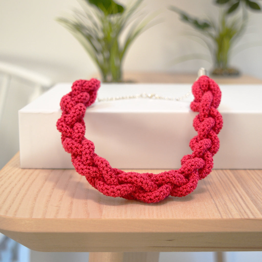 Red braided necklace completed from the braided necklace crochet kit