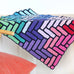 colourful modern crochet blanket using herringbone pattern draped on table