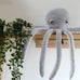 amigurumi octopus crochet kit sitting on table with tentacles dangling