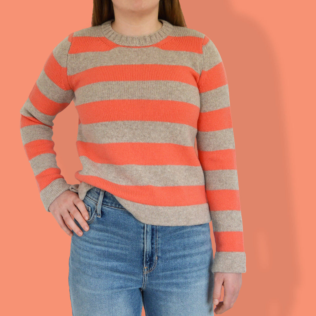 woman wearing orange and beige stripe modern jumper from knitting pattern.  modern knitting kit.  sweater knitting pattern. fun knitting easy to knit