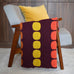 mid century modern retro crochet blanket draped on chair with dark wood background