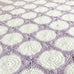 close up of white circles and lilac border granny square blanket