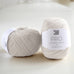 ball of white knitting yarn on table, pure wool, british yarn
